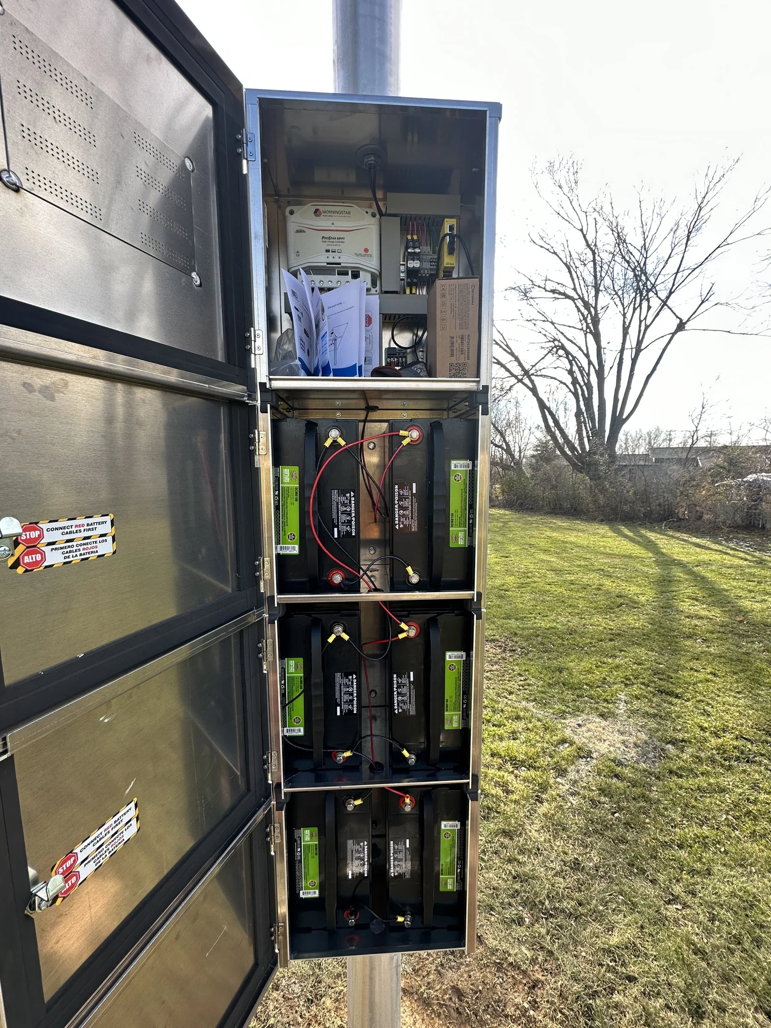 Battery backup enclosure at pole base